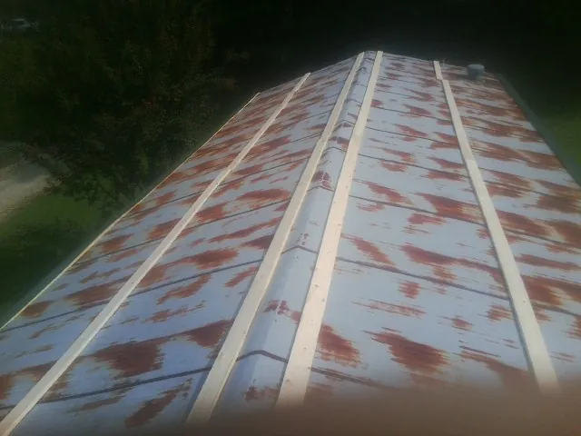 Rusted metal roof panels with new wood purlins before replacement — Storm Damage Roof Repair in Tetonia by Roofing Brothers